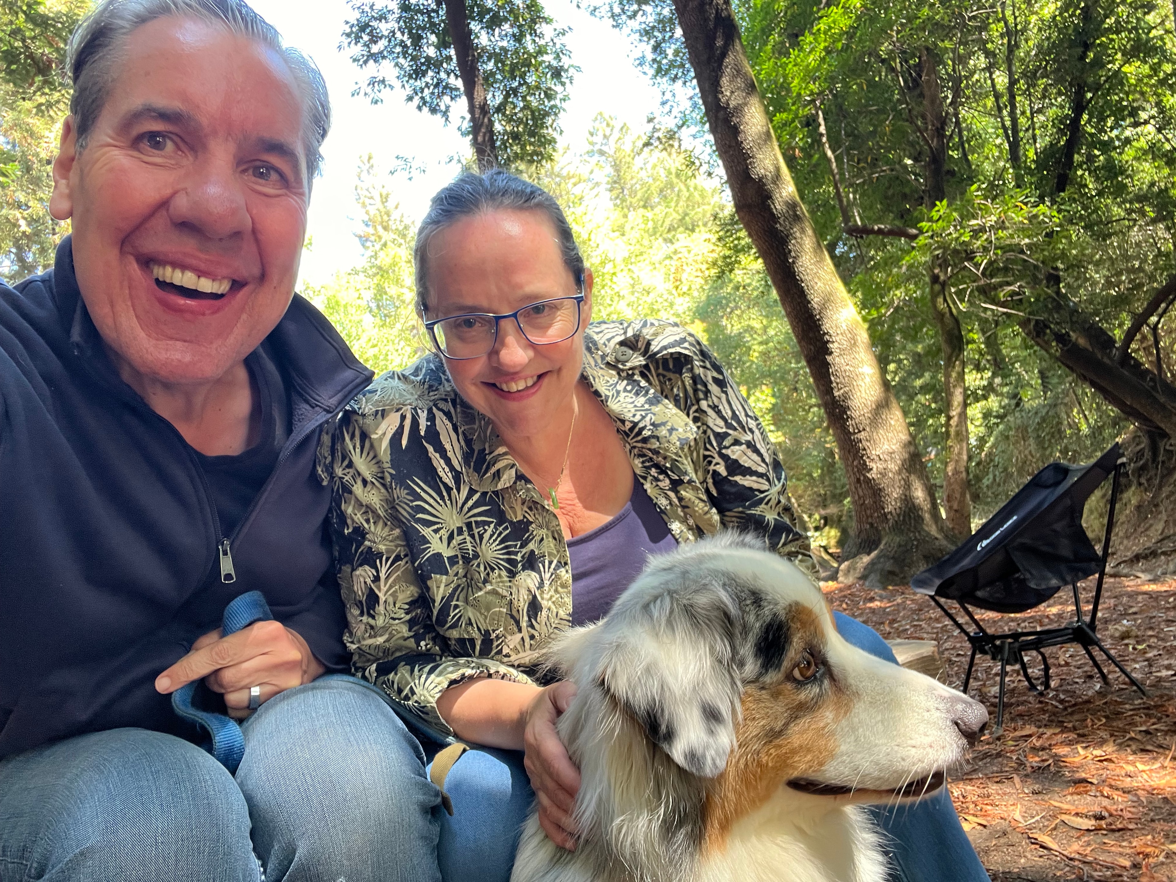 Maggie and Douglas with their Australian Shepherd in a redwood forest setting